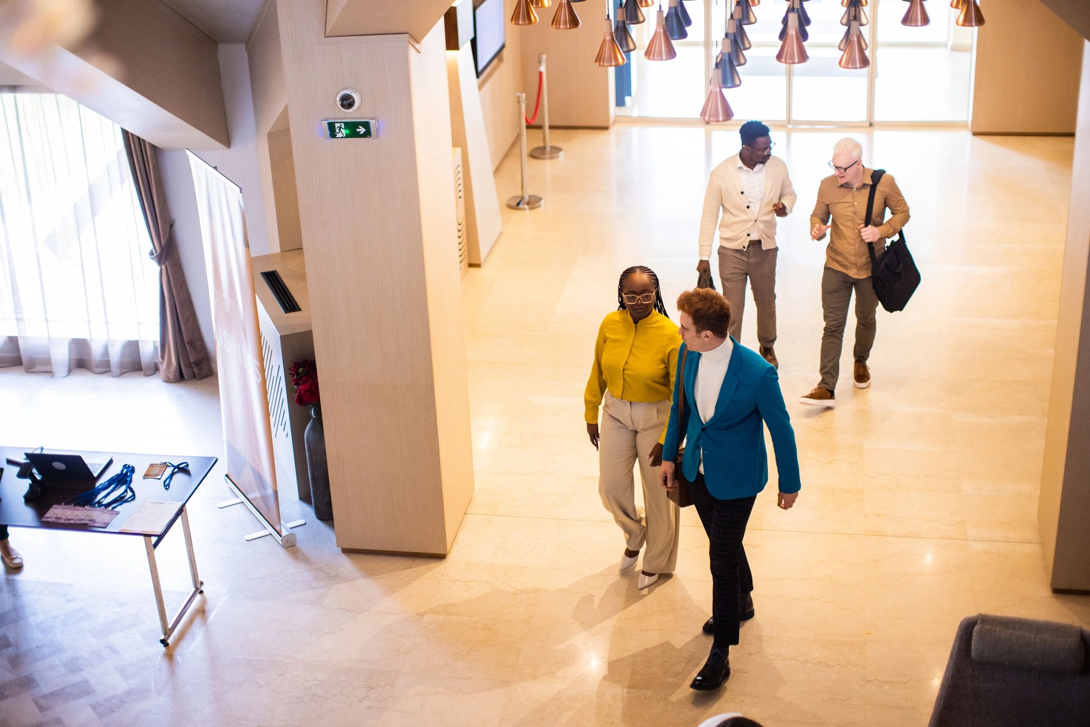 Group entering a hotel lobby near a registration desk