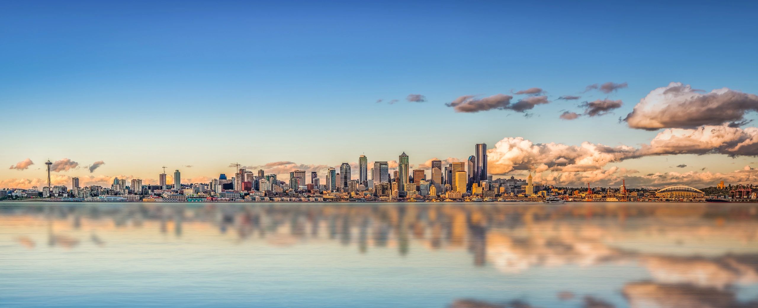 Seattle skyline reflected on water at dusk